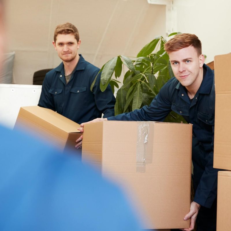 removal-company-workers-unloading-furniture-and-boxes-from-truck-into-new-home-on-moving-day-1.jpg